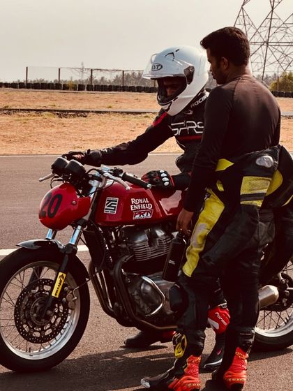 A coach gives instructions to a rider on the starting grid. This personalized guidance is crucial for building confidence and ensuring riders are prepared for every session.