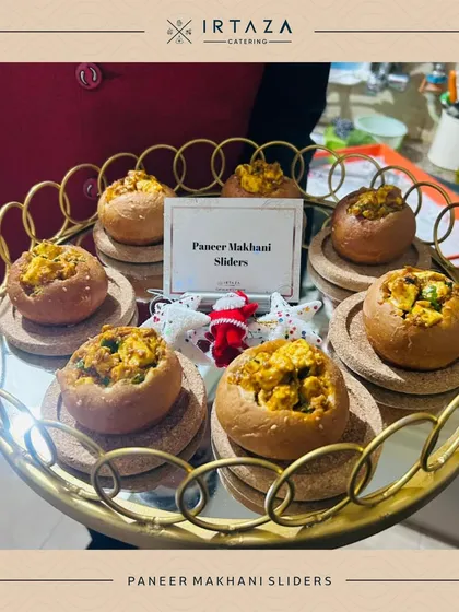 Paneer Makhani Sliders, a creative fusion dish. Soft buns are hollowed out and filled with rich, creamy paneer makhani, offering a comforting and delicious bite.