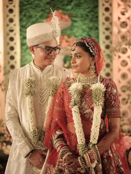A look of love. The bride's bold makeup is softened by the romantic moment shared with her groom.