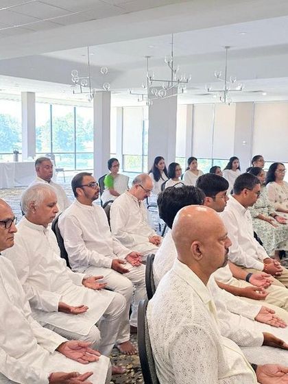 Participants dressed in white meditate during our program in the USA. The uniform color helps in creating a sense of unity and equality among all seekers.