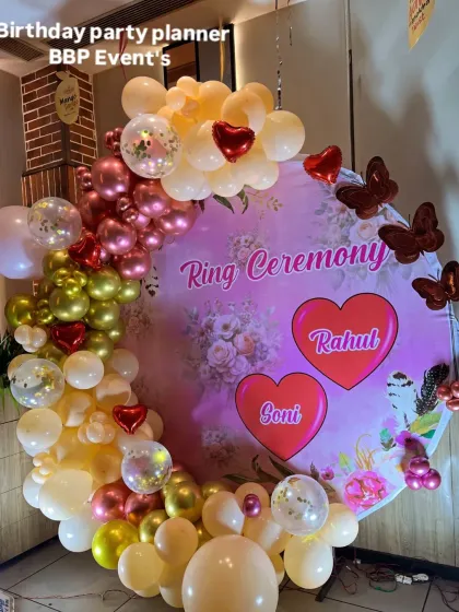 A close-up of the romantic ring ceremony backdrop, highlighting the custom names and butterfly accents.