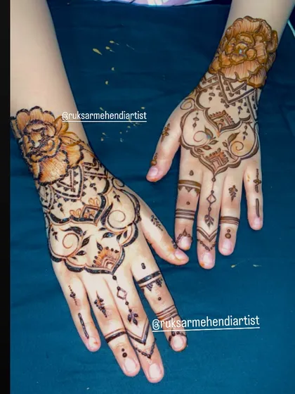 A fusion design combining a traditional mandala on one hand with a minimalist finger design on the other.