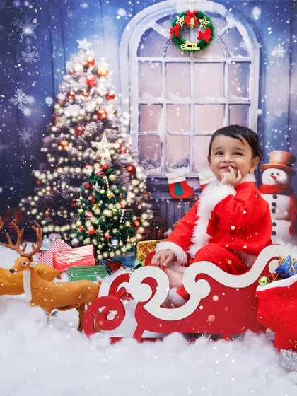 A baby Santa sits in his sleigh, ready to deliver presents in this magical, snowy Christmas scene.