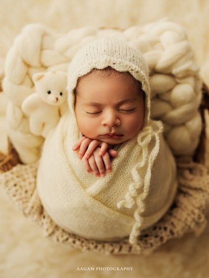 So tiny and perfect, this little one is nestled in a basket with a soft wrap and a tiny teddy bear friend. These small details add a touch of sweetness to the portrait.