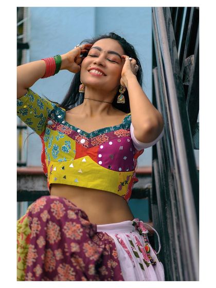 A joyful and vibrant portrait of a woman in colorful traditional attire. This image captures a feeling of celebration and happiness.
