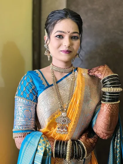 A close-up portrait of the bride, showcasing her intricate jewellery and the subtle makeup that enhances her features.