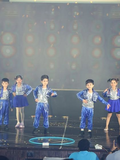 Our youngest students in their shiny blue costumes for the "Rocky Rani" themed performance.
