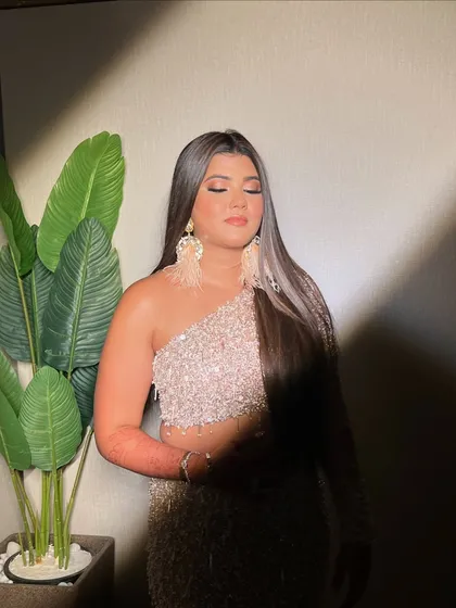 A serene moment showing the soft side of this glam look. The pink-toned eyeshadow adds a touch of romance to the overall party vibe.