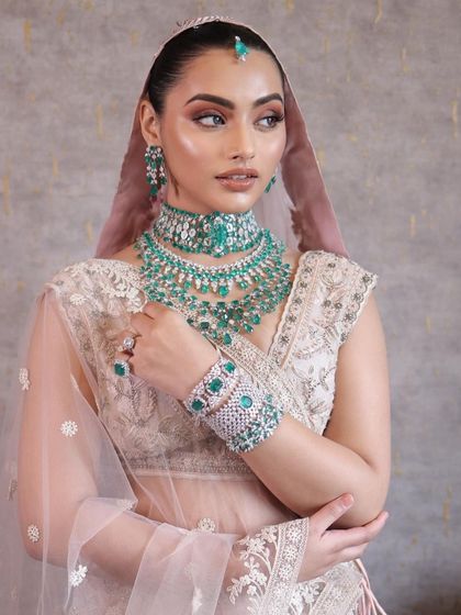 This look is about pairing soft pastels with statement diamond and emerald jewellery. The makeup is clean and luminous, with a focus on the eyes to create a balanced and sophisticated bridal style.