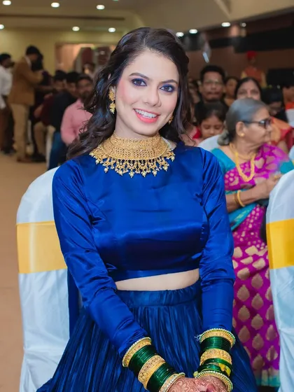 The bride looking radiant and happy at her sangeet. The blue smokey eye is the star of this glamorous look.