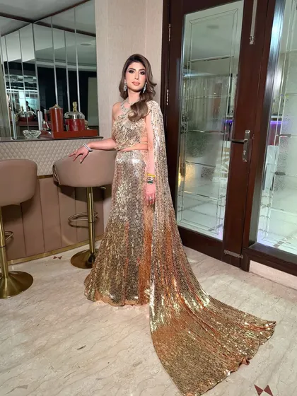A dramatic full-length shot showing the incredible train of the Manish Malhotra sequin sari-gown. The makeup is bold enough to match this show-stopping look.