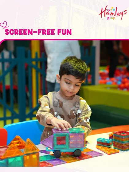 We love screen-free fun! This Valentine's, create memories that feel like magic with a playdate. Here a child is building with translucent blocks, a perfect activity for shared laughter.