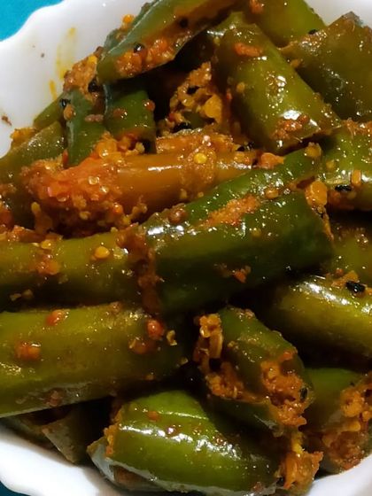 A bowl of my freshly made Green Chilli Pickle. The chillies are slit and filled with a masala mix, ensuring flavour in every single piece.