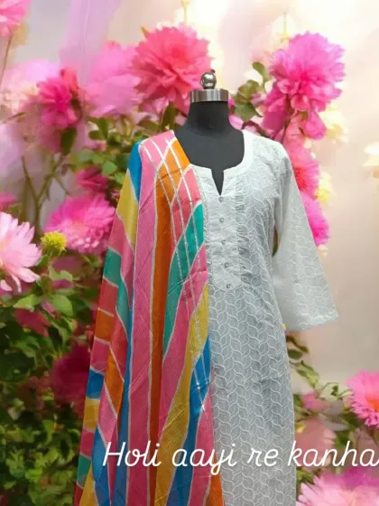"Holi aayi re kanhai..." This image captures the spirit of Holi with a classic white chikankari kurta paired with a vibrant, multi-colored leheriya dupatta.
