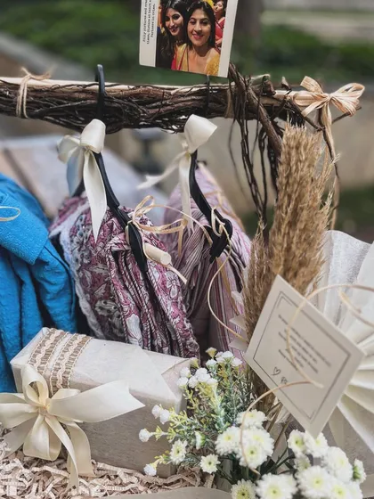 Another angle of the hanger hamper, focusing on the textures of the fabrics and the rustic charm of the woven tray. Every element is carefully chosen to create a cohesive and beautiful story.