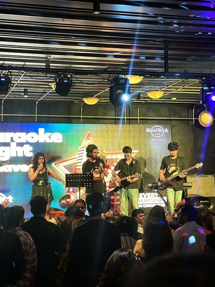 The full band on the Hard Rock Cafe stage during a Karaoke Night. We had electric guitars, bass, keyboards, and drums for a full rock-out session.