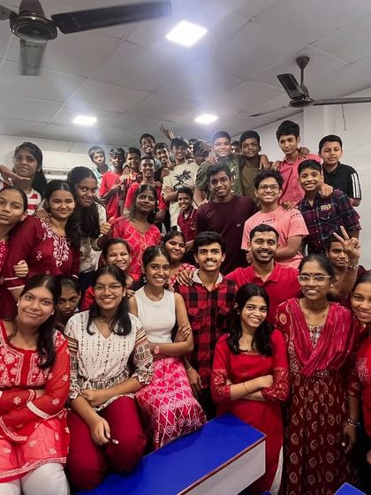 A classroom filled with red for Day 2 of Navratri, symbolizing energy and passion. The participation from everyone is fantastic.