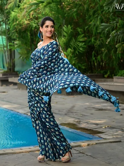 A dynamic shot of the elephant-print saree in motion. The flowing 'pallu' creates a sense of energy and joy, perfectly capturing the light and breezy feel of the cotton fabric.