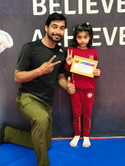 Thumbs up from the coach for this student who just earned her new certificate.