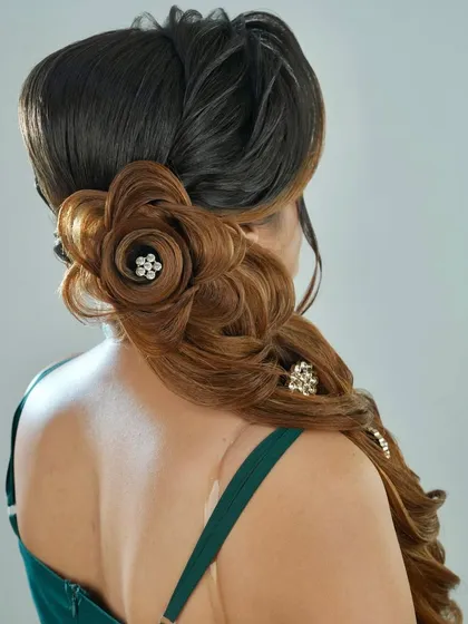 A view from the back, highlighting the detailed floral hair sculpture and the flow of the braid.