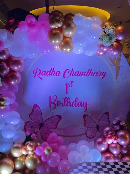 The personalized backdrop with butterfly details looks so pretty under the party lights. I can customize the text with your baby's name and birthday message.