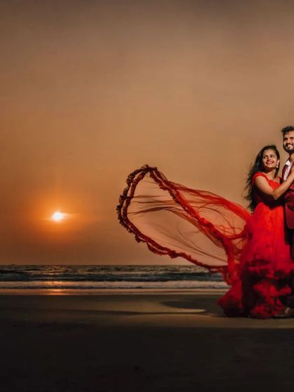 A breathtaking sunset beach photo. This couple rented a matching red gown and suit from my collection to create this incredibly romantic and cinematic pre-wedding shot.