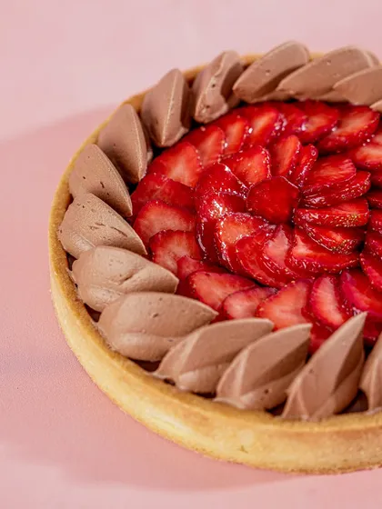 The Strawberry Chocolate Tart, showing the contrast between the dark, rich chocolate piping and the bright red of the strawberries.