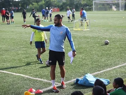 Our on-field coaching is practical and direct. This image from the FIFA Women's Development Programme shows our coach providing real-time instruction to players during a strength and conditioning drill.