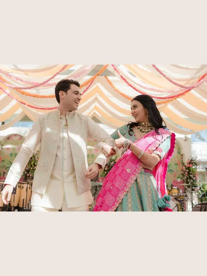 A playful dance move during a colorful pre-wedding event in Jaipur. We capture the fun and energy of celebrations, ensuring your photos are full of life and personality.