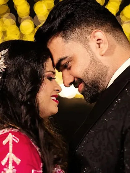A close-up portrait filled with warmth and affection. The soft glow of the fairy lights creates a romantic atmosphere, perfect for capturing the intimacy of an engagement celebration. It's these emotional portraits that truly tell your love story.