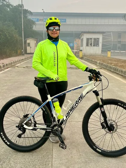A female cyclist with her Lapierre bike on a foggy morning. She is ready to take on any challenge.