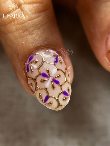 A macro shot of the purple and gold floral mosaic, showing the precision of each hand-painted petal and chrome outline.