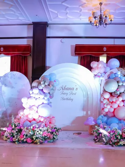 Welcome to a fairy wonderland. For this first birthday, we transformed the space with dreamy pastel balloon clouds, oversized paper flowers, and magical mushroom props, creating an enchanted forest for everyone to explore.