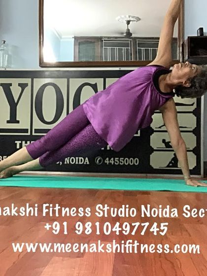 A side plank pose, demonstrating full-body engagement from the supporting hand to the extended foot.