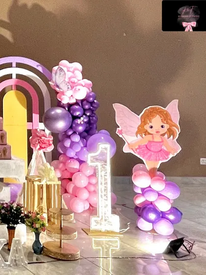 A detail shot showing the light-up number '1' and a fairy cutout on a balloon pedestal, adding to the magical ambiance.