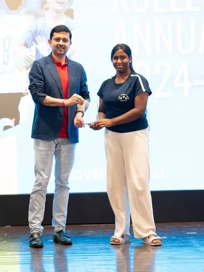 An Xcelerate program girl receiving her award on stage. We celebrate every achievement.