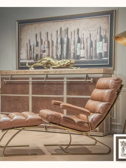 Our Bolshoy automated bar, seen here as a sophisticated console, complements a luxurious leather lounge chair. This demonstrates how our pieces integrate seamlessly into high-end living spaces, providing function without compromising style.