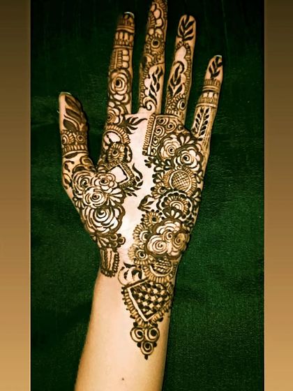 A fusion design that combines the boldness of Arabic florals with the intricacy of Indian patterns. Notice the checkerboard fill and delicate details next to the large rose motifs.