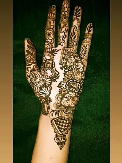 A fusion design that combines the boldness of Arabic florals with the intricacy of Indian patterns. Notice the checkerboard fill and delicate details next to the large rose motifs.