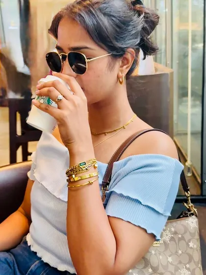This photo captures a natural moment, showing how the jewellery pieces complement a casual outfit. It's a great example of subtle product placement in a lifestyle context.