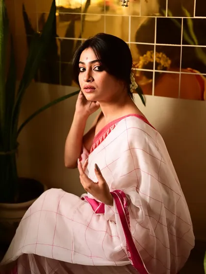 A full-seated portrait from the Tagore-inspired series. The composition uses shadows and a simple setting to evoke a sense of quiet introspection and timeless Bengali elegance.