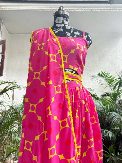 The matching crop top and draped dhoti pants create a fun and modern silhouette.