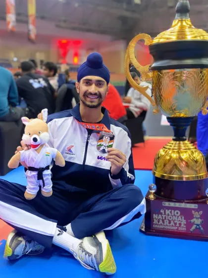 Celebrating the team's success at the 4th KIO National Karate Championship with the trophy. Individual medals are great, but team trophies represent collective strength.