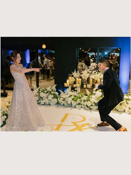 A playful moment on the dance floor. The reception styling featured clean lines, white florals, and warm candlelight, creating a modern and elegant atmosphere for a night of celebration.