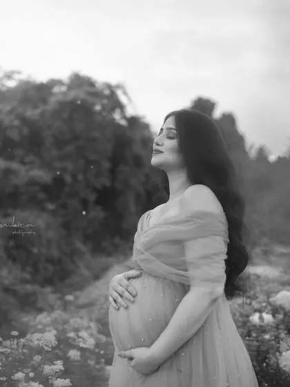 A candid moment of bliss, captured in black and white. Her eyes are closed as she soaks in the moment, creating a peaceful and emotionally resonant portrait.