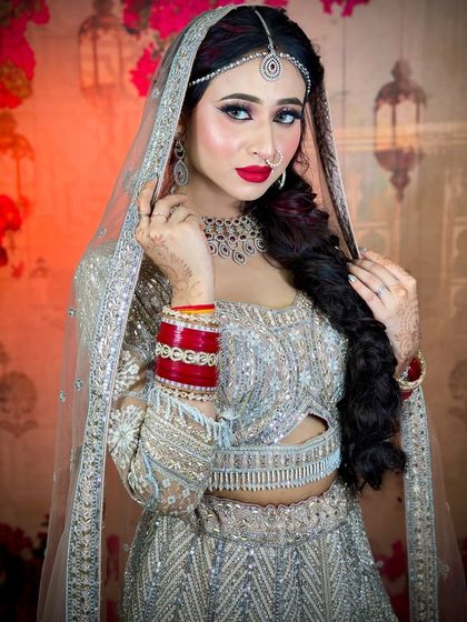 A beautiful portrait of the bride. The red lipstick adds a pop of color to the otherwise subtle and shimmery look.
