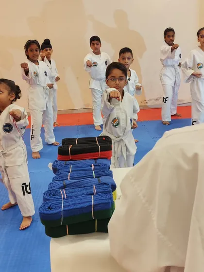 A group of our youngest students learns the basic ready stance, their eyes fixed on the instructor. Discipline and focus are taught from day one.