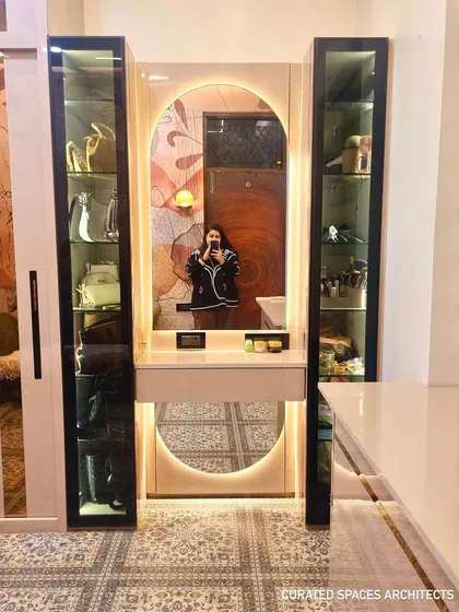 For me, great design is in the details, like this custom closet and dressing area. I designed this space with illuminated glass cabinets to beautifully display accessories, a well-lit vanity, and ample storage to make getting ready a truly joyful experience.