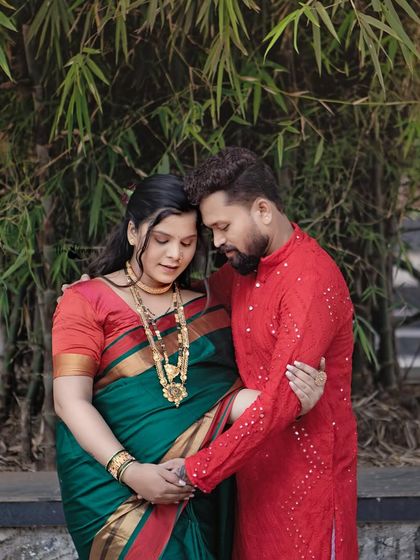 Framed by bamboo, the couple shares a quiet, loving moment. The natural elements complement their traditional outfits beautifully.