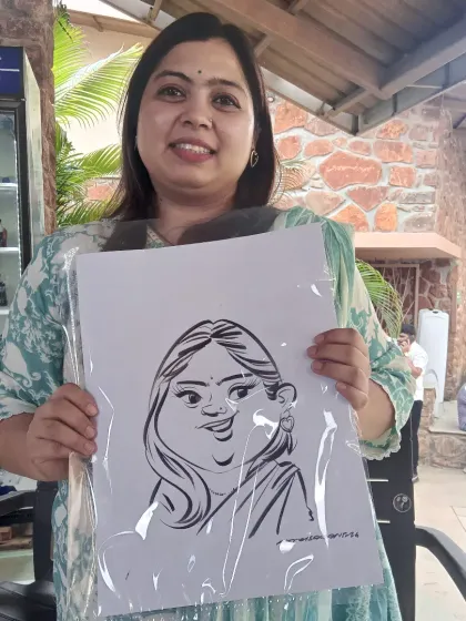 A happy guest with her black and white ink caricature. The simplicity of the style really lets the personality shine.